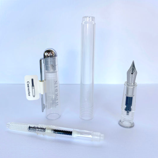 Jacques Herbin Stylo plume transparent à pompe chez millenotes - elements